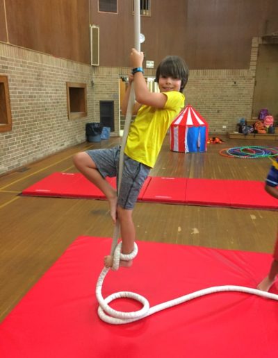 Boy climbing rope